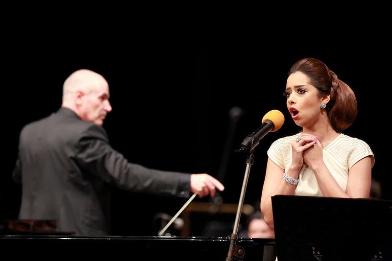 The National Symphony Orchestra conductor Andy Berryman, left, and the Emirati soprano Balqees Al Fathi perform at the ABu Dhabi National Theatre. Courtesy NSO