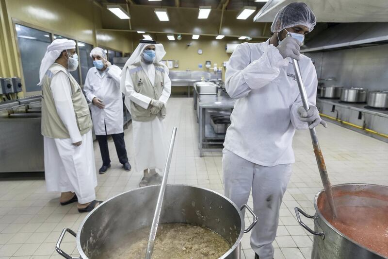 DUBAI, UNITED ARAB EMIRATES. 27 APRIL 2020. Dar Al Ber Iftar meal preparation for handing out as part of their charity work at the Modern Bakery in Al Quoz. Bulk prepared food is packed for individual consumption. Dr Hisham Al Zahrani inspects the food packaging. (Photo: Antonie Robertson/The National) Journalist: None. Section: National.