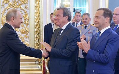 Former German chancellor Gerhard Schroeder, centre, is a personal friend of Russian President Vladimir Putin. AFP 