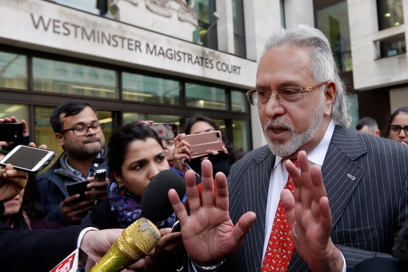 In this, Monday, Dec. 10, 2018, file photo, Indian businessman Vijay Mallya is surrounded by the media as he leaves Westminster Magistrates Court in London. An Indian court has declared tycoon Vijay Mallya a fugitive economic offender, a ruling that empowers authorities to confiscate his properties and assets. (AP Photo/Kirsty Wigglesworth)