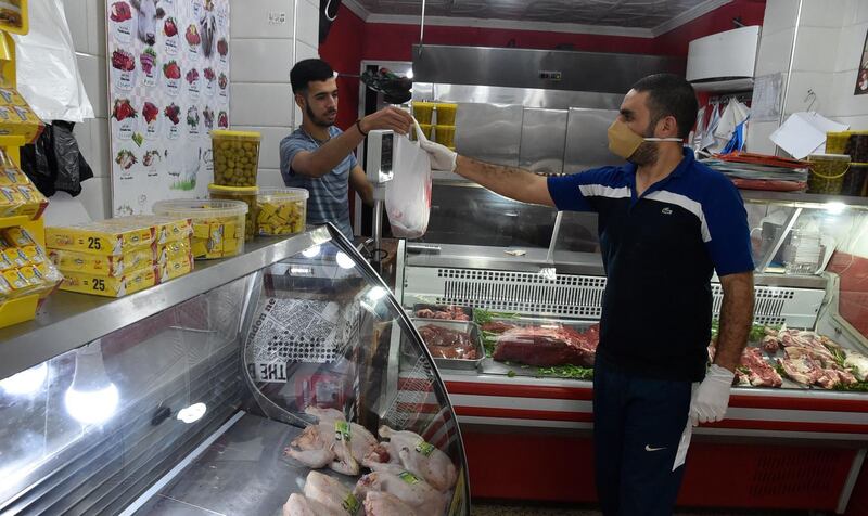 An Algerian man buys meat at a butcher's shop in the capital Algiers. AFP
