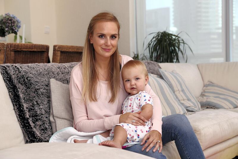 DUBAI , UNITED ARAB EMIRATES , OCT 26   – 2017 :- Tamsin Foster with her one month old daughter Layla Foster at her apartment in the Delphine Tower in Dubai Marina in Dubai. (Pawan Singh / The National) Story by Krysia McKechnie