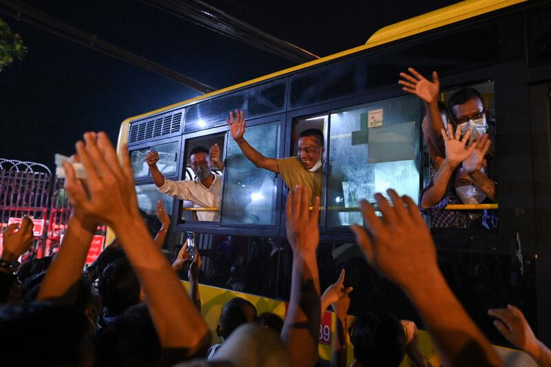 Newly-released prisoners wave to the crowds. AFP