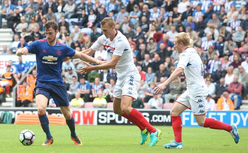 WIGAN, ENGLAND - JULY 16:  Will Keane of Manchester United in action with Dan Burn of Wigan Athletic during the pre-season friendly match between Wigan Athletic and Manchester United at JJB Stadium on July 16, 2016 in Wigan, England.  (Photo by Matthew Peters/Manchester United via Getty Images)