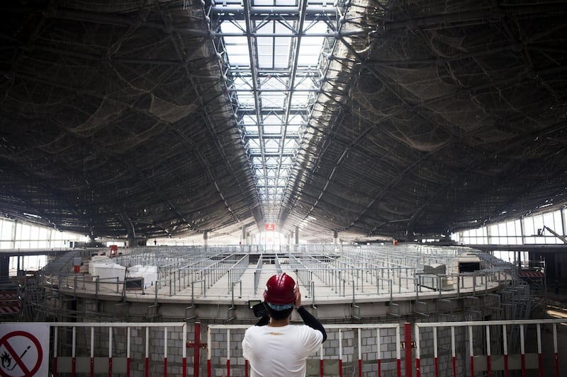 An attendee takes a photograph of a terminal building at Beijing's new international airport in China. Giulia Marchi / Bloomberg