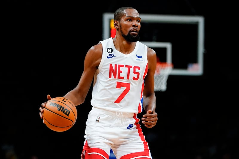 Brooklyn Nets' Kevin Durant looks to pass during the second half of the NBA game against the San Antonio Spurs on Monday in New York. The Nets won 139-103. AP