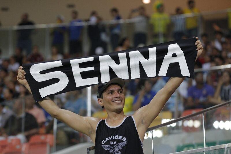 A Corinthians supporter holds up a banner displaying Ayrton Senna's name before the football match on Wednesday. Corinthians were Senna's favourite club. Bruno Kelly / Reuters / April 30, 2014