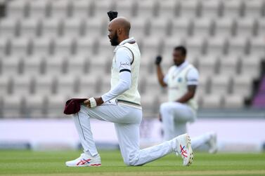 SOUTHAMPTON, ENGLAND - JULY 08: Roston Chase of the West Indies takes a knee during day one of the 1st #RaiseTheBat Test match at The Ageas Bowl on July 08, 2020 in Southampton, England. (Photo by Mike Hewitt/Getty Images)