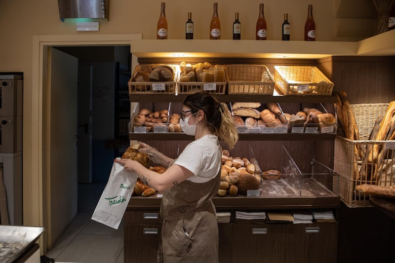 A baker handles some bread at Tresoldi Bakery in Bergamo, Italy, as the city is slowly returning to normality after the lockdown. Getty Images