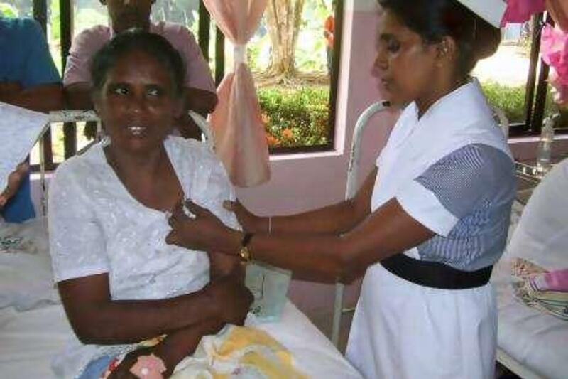 A Sri Lankan housemaid (L), who returned from Saudi Arabia with 24 nails inside her body, talks to a nurse while receiving treatment at a hospital in Batticoloa on August 25, 2010. The maid, L.T. Ariyawathi, 49, alleged that her Saudi employer had tortured her and drove nails into her body as punishment. Police said they have begun a probe into the matter. According to Sri Lanka's Foreign Employment Bureau, around 1.8 million Sri Lankans are employed abroad and 70 percent of them are women. Most of them are employed as housemaids in the Middle East, while smaller numbers are in Singapore and Hong Kong. AFP PHOTO/STR

 *** Local Caption ***  057785-01-08.jpg