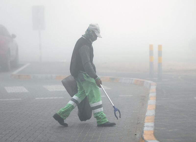 Abu Dhabi, United Arab Emirates, December 30, 2019.  
A municipality worker cleaning up the streets on a foggy morning at Khalifa City, Abu Dhabi.
Victor Besa / The National
Section:   NA 
Reporter: