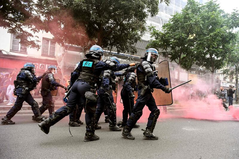 Police charge demonstrators during clashes at the end of a national day of protest against French legislation making a Covid-19 health pass compulsory to visit a cafe, board a plane or travel on an inter-city train, in Paris.