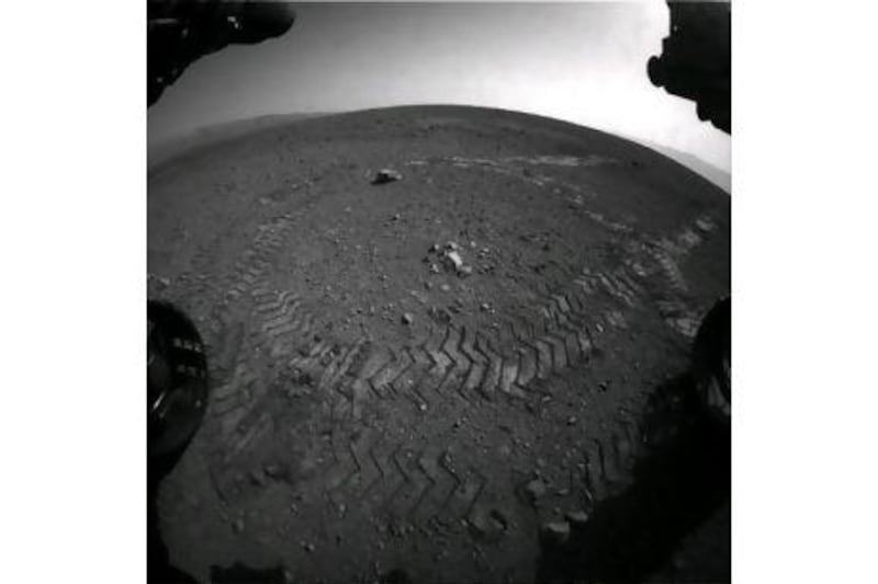 A photograph of Mars released by Nasa last week shows the tracks of its Curiosity Rover as it completes its first test. EPA/NASA JPL CALTECH