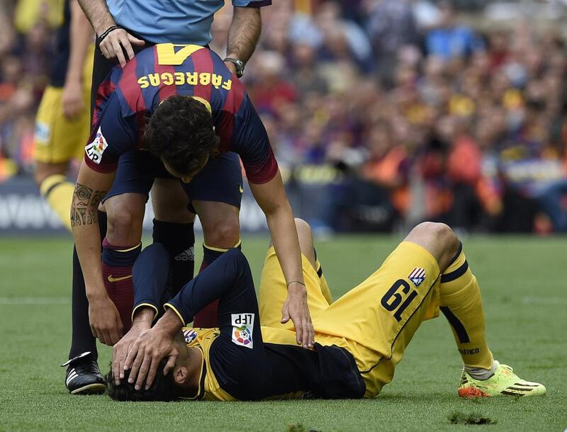 Atletico Madrid forward Diego Costa, ground, reacts to an injury during Saturday's match against Barcelona. Lluis Gene / AFP / May 17, 2014