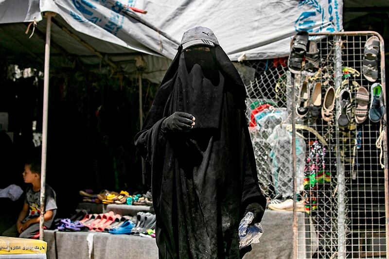 A woman stands inside Al Hol camp for displaced people in Al Hasakeh in northeastern Syria. AFP
