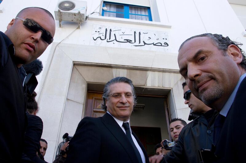 FILE - In this April 19 2012 file photo, Nabil Karoui, center, head of Tunisian TV Nessma channel, arrives at the courthouse in Tunis. With more than half the votes in Tunisia's presidential race counted, jailed media magnate Nabil Karoui arrived second while Kais Saied, a former conservative constitutional law professor, was in the lead. (AP Photo/Amine Landoulsi, File)