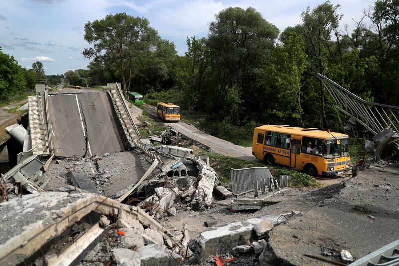 An evacuation convoy travels along a damaged road from the town of Kupiansk on the outskirts of Kharkiv. Reuters