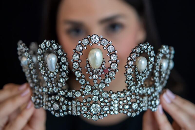 A Sotheby's employee displays a diamond and pearl tiara passed down through generations of the Italian royal family. AP Photo