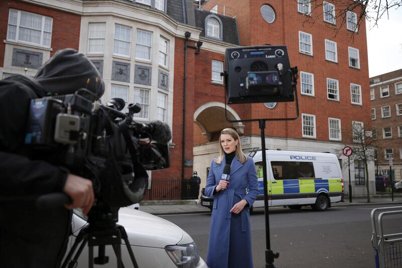 A TV reporter speaks outside King Edward VII's Hospital. Reuters