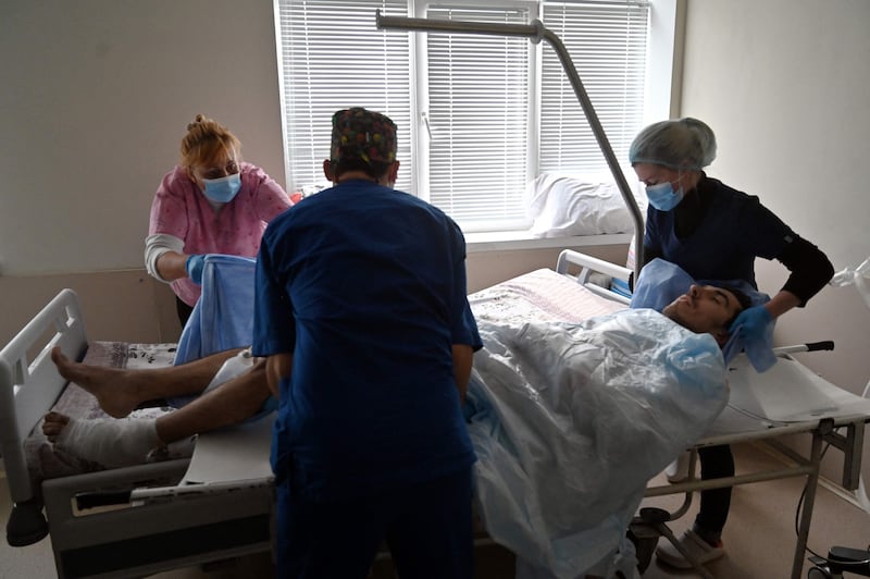 Medical workers tend to a Ukrainian serviceman wounded during the fighting with Russian troops near the Ukrainian capital, in a hospital in Kyiv. AFP