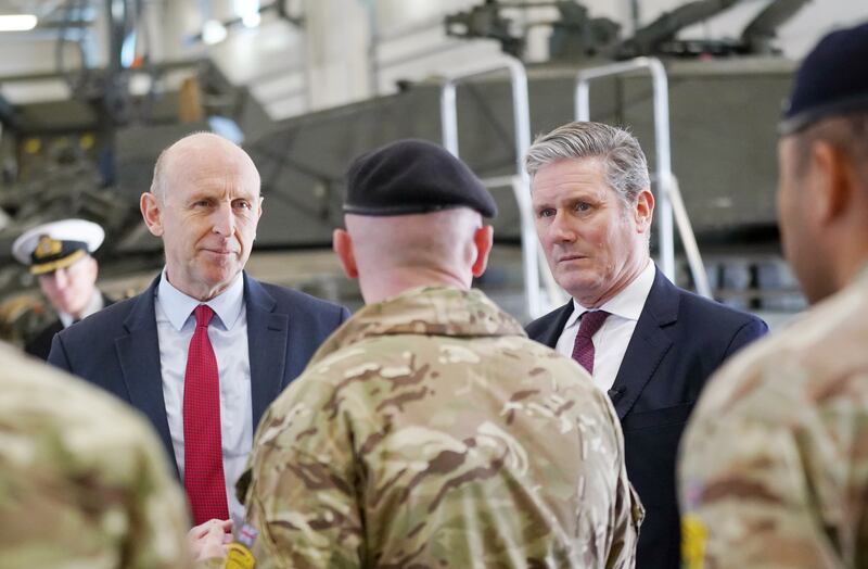 Labour leader shadow defence secretary John Healey (left) talks to troops during a visit to Tapa Military Base in Estonia. PA
