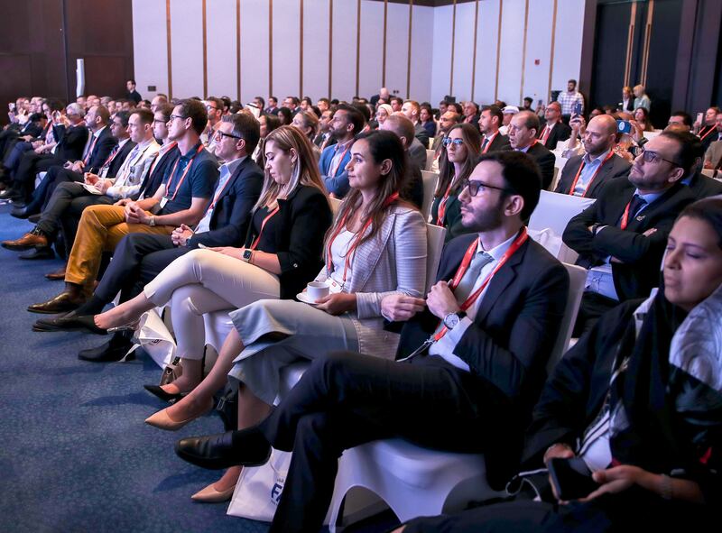 The audience listens to a speech by Bill Gates.