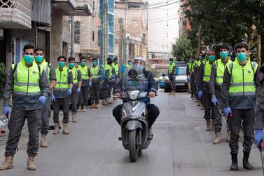 Volunteers from Hezbollah's medical wing, the Islamic Health Society, prepare to disinfect streets in southern Beirut as part of the Lebanese group's initiatives to deal with the country's coronavirus outbreak. Reuters