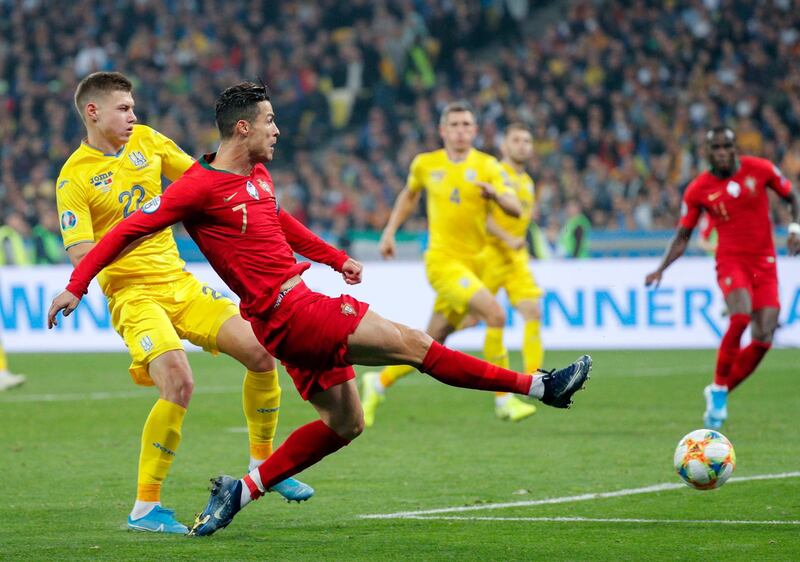 epa07921198 Cristiano Ronaldo (C) of Portugal and Mykola Matviyenko (L) of Ukraine in action during the UEFA Euro 2020 qualifying, group B, soccer match between Ukraine and Portugal in Kiev, Ukraine, 14 October 2019.  EPA/SERGEY DOLZHENKO