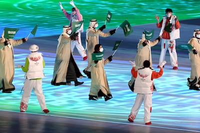 Members of Team Saudi Arabia wave flags at the opening ceremony of the Beijing 2022 Winter Olympics. Getty Images