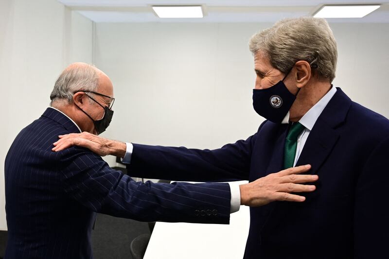 US climate envoy John Kerry, right, greets former French premier and foreign minister Laurent Fabius, who oversaw the 2016 Paris Agreement on climate change. AFP