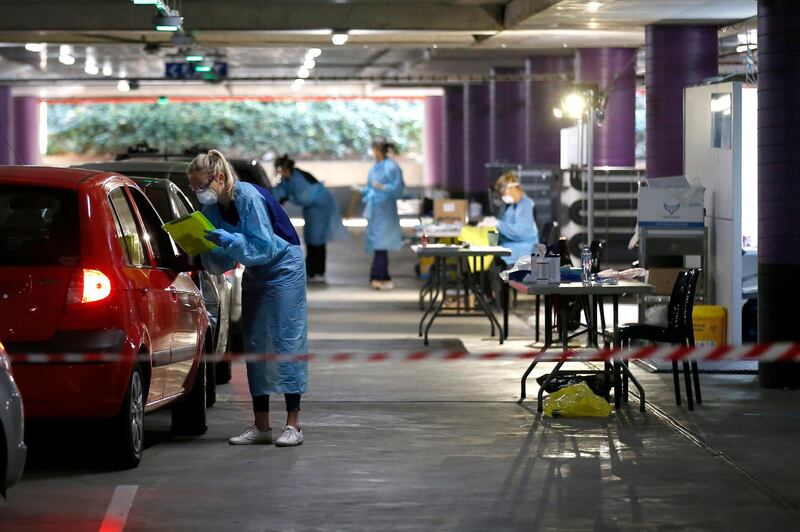 Medical practitioners take information from members of the public at a drive through testing clinic in the carpark of Victoria Gardens Shopping Centre in Melbourne, Australia. Getty