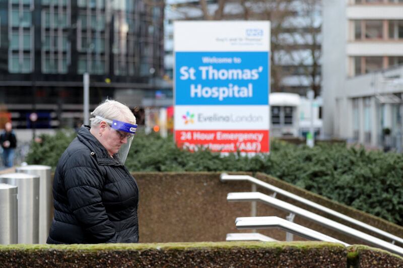 A visitor to St Thomas' Hospital in London wearing personal protective equipment. Reuters