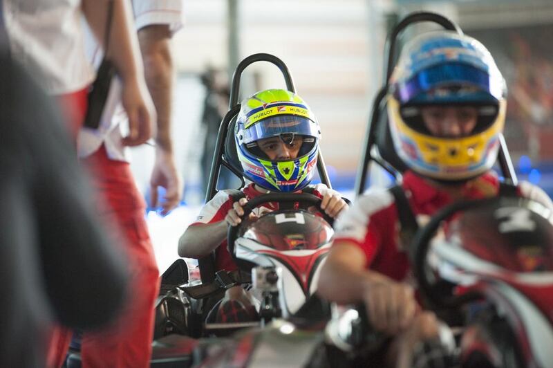 Ferrari drivers Felipe Massa, left, and Fernando Alonso, test drive the latest attraction at Ferrari World Abu Dhabi. Photo Courtesy-Ferrari World