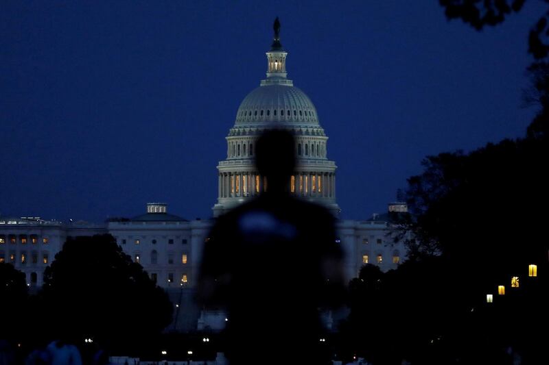 People walk past the US Capitol Building in Washington. Reuters