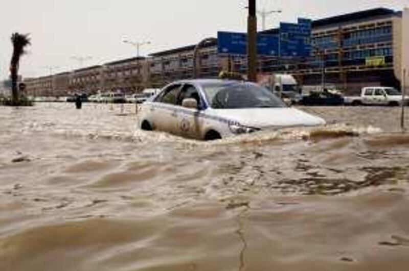 Feb 28, 2010 / Sharjah / A taxi driver goes through high water after heavy flooding along the  311 in Sharjah caused by heavy rains last  night Feb 28, 2010. (Andrew Henderson / The National)

