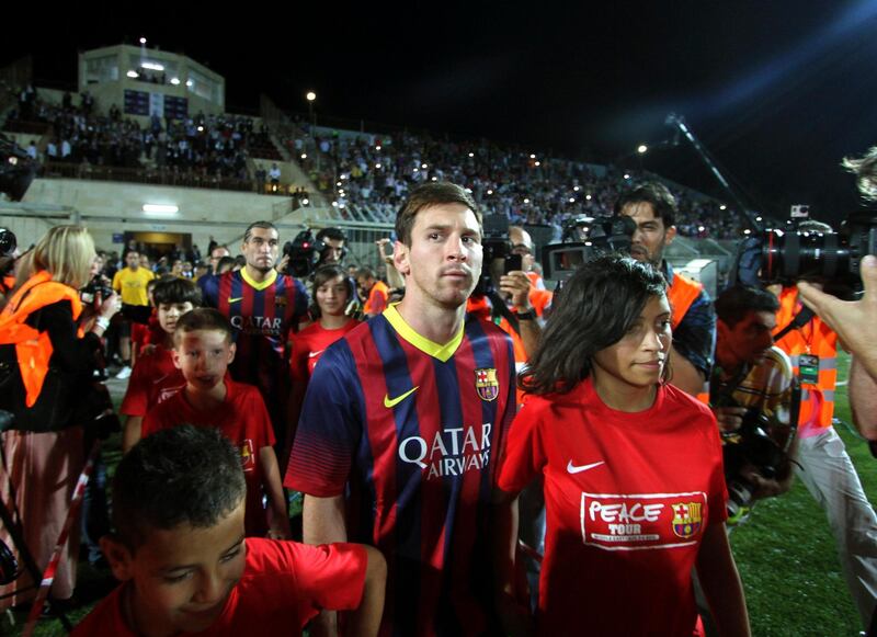 FC Barcelona's Argentine striker Lionel Messi enters a stadium for a football clinic session with Palestinian children in the West Bank city of  Hebron, Saturday, Aug. 3, 2013. The Spanish club arrived in the region Saturday with superstars Messi and Neymar touching down in Tel Aviv. They then headed to Bethlehem, where they visited Jesus' traditional birthplace and met with Palestinian President Mahmoud Abbas. (AP Photo/Nasser Shiyoukhi) *** Local Caption ***  Mideast Palestinians Soccer Barcelona Middle East Trip.JPEG-0986e.jpg