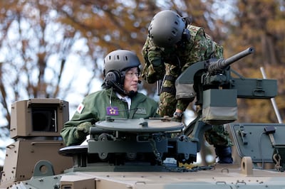 Japanese Prime Minister Fumio Kishida rides on a Japan Ground Self-Defence Force Type 10 tank in November 2021. AP Photo