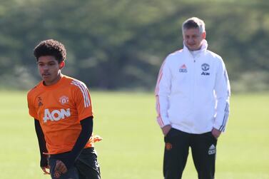 Shola Shoretire is watched by Manchester United boss Ole Gunnar Solskjaer in training. Getty