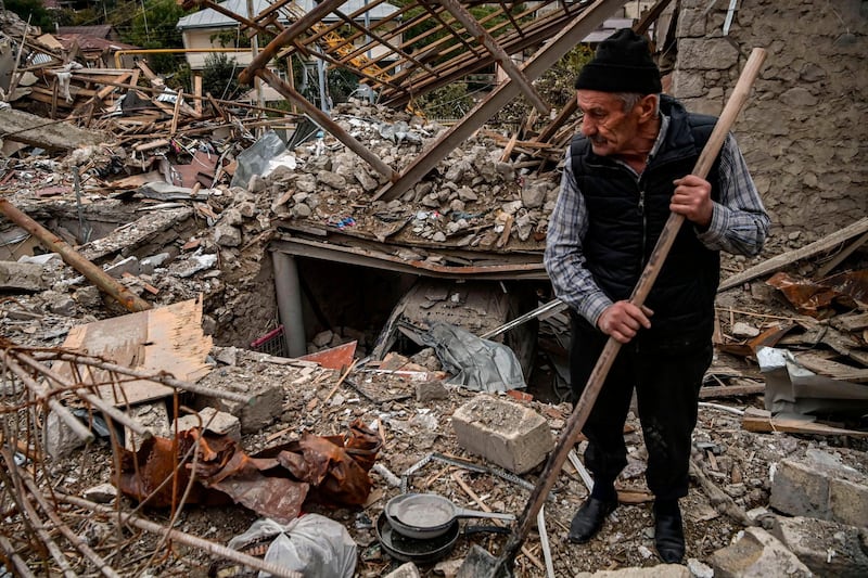 Retired police officer Guennadi Avanessian, 73, searches for belongings in the remains of his house, which he said was destroyed by Azeri shelling, in the city of Stepanakert. AFP