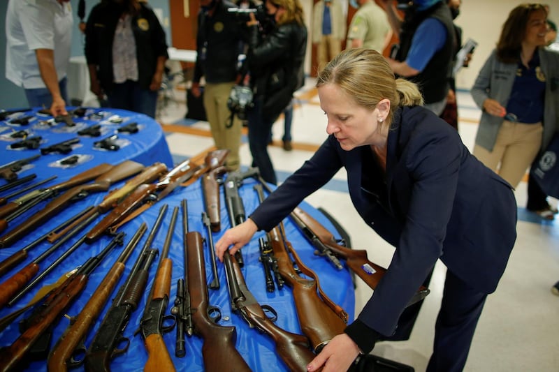 Queens District Attorney Melinda Katz grabs a rifle after a gun buyback event organized by the New York City Police Department (NYPD), in the Queens borough of New York City, U.S. Reuters