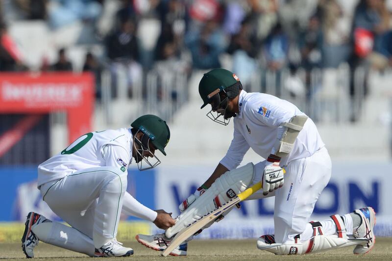 Pakistan's Abid Ali helps Bangladesh batsman Saif Hassan during the third day of the first Test. AFP