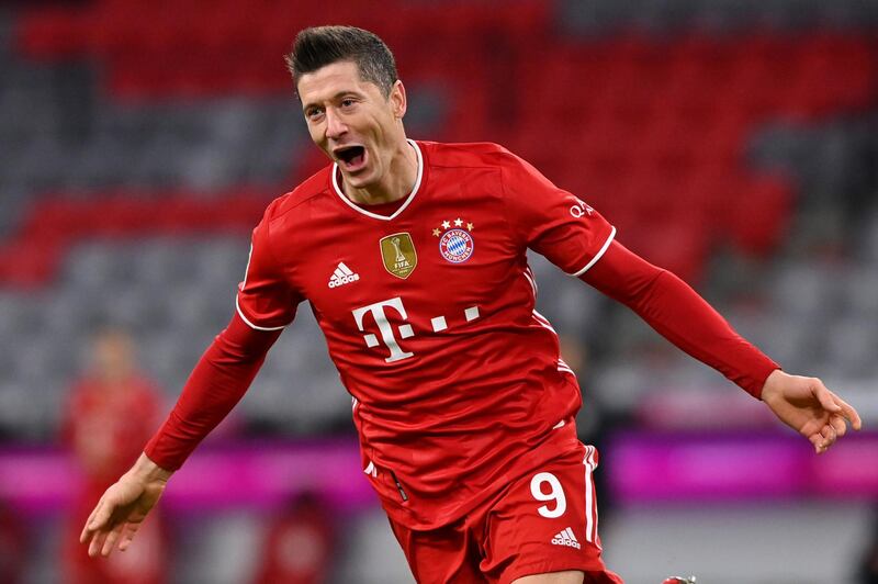 *** BESTPIX *** MUNICH, GERMANY - MARCH 06: Robert Lewandowski of FC Bayern Muenchen celebrates after scoring their team's fourth goal, completing his hat-trick during the Bundesliga match between FC Bayern Muenchen and Borussia Dortmund at Allianz Arena on March 06, 2021 in Munich, Germany. Sporting stadiums around Germany remain under strict restrictions due to the Coronavirus Pandemic as Government social distancing laws prohibit fans inside venues resulting in games being played behind closed doors. (Photo by Sebastian Widmann/Getty Images)