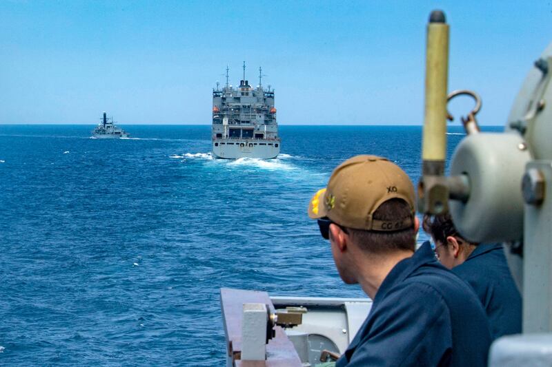 The guided-missile cruiser USS  Shiloh, the Military Sealift Command dry cargo and ammunition ship USNS Cesar Chavez and the coastal patrol ship USS Whirlwind seen as they transit the Strait of Hormuz.  (Rawad Madanat/US NAVY/AFP).