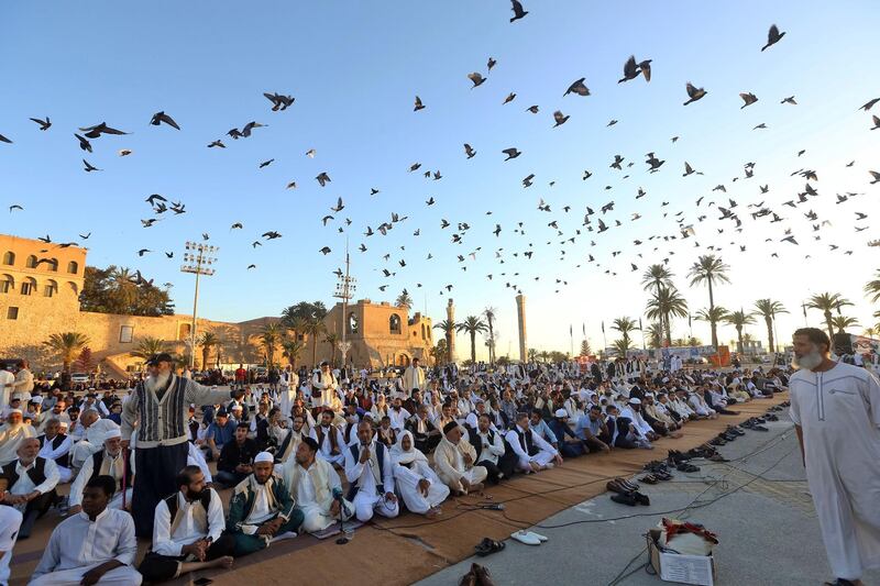 Libyan Muslim worshippers gather to perform Eid Eid Al Fitr prayers at the Martyrs Square of the capital Tripoli. AFP