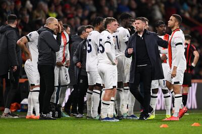 Luton manager Rob Edwards, second right, with his players after Tom Lockyer's collapse. Getty Images