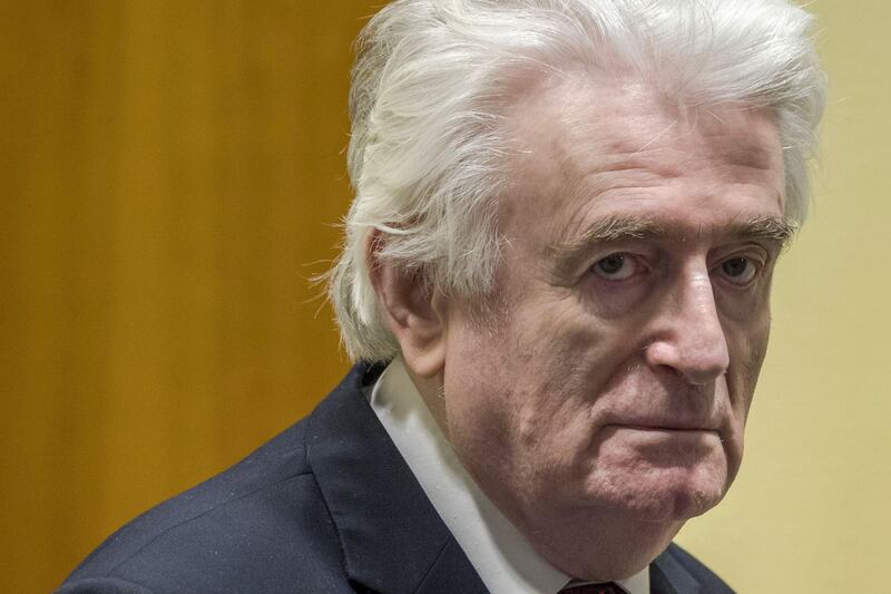 Former Bosnian Serb leader Radovan Karadzic reacts at the court room of the International Residual Mechanism for Criminal Tribunals in The Hague, Netherlands, on March 20, 2019, while waiting to hear the final judgement on his role in the bloody conflict that tore his country apart a quarter of a century ago.
  Karadzic is sentence to life imprisonment by UN judges on March 20, 2019. Radovan Karadzic  was notorious for his role in the 1995 Srebrenica massacre where more than 8,000 Muslim men and boys were slaughtered in the worst bloodletting on European soil since World War II.  / AFP / POOL / Peter Dejong
