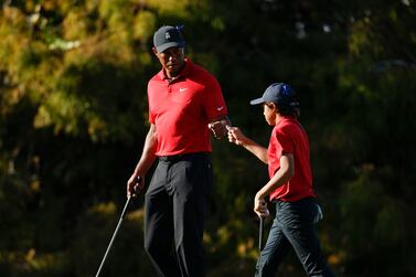 FILE  -Tiger Woods fist bumps his son Charlie Woods on the 16th green during the second round of the PNC Championship golf tournament, Sunday, Dec.  19, 2021, in Orlando, Fla.  Speculation for 2022 starts with where Woods will show up next on the PGA Tour.  (AP Photo / Scott Audette, File)