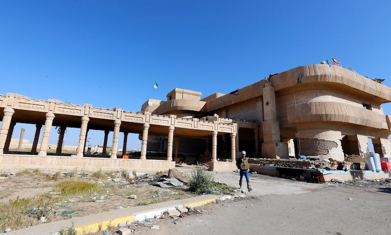 A Shiite fighter from Al-Hashid Al-Shaabi (Popular Mobilization Forces) walks outside Saddam's palaces in the Iraqi town of Ouja, near Tikrit, on March 17, 2015. Reuters