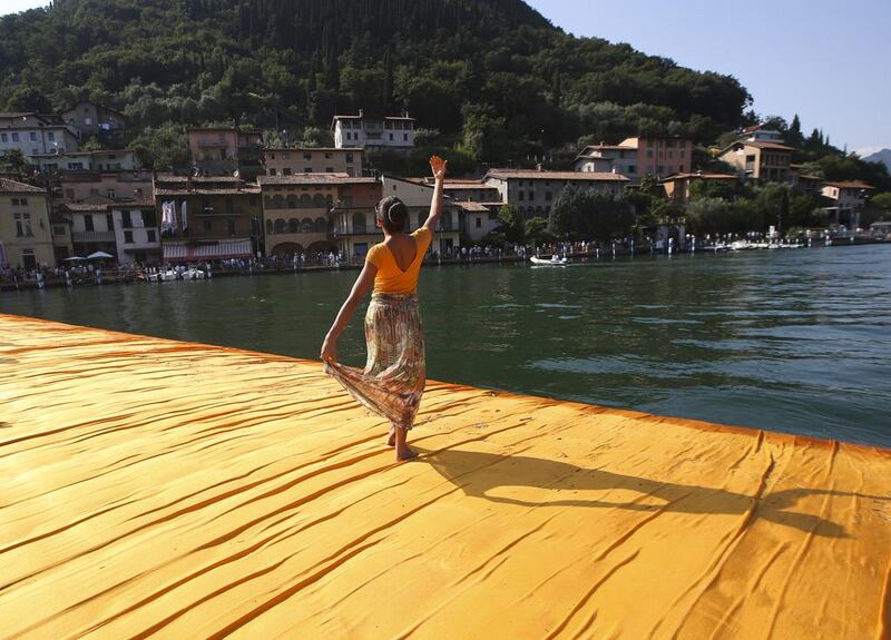 A woman enjoys the installation entitled The Floating Piers at the Iseo Lake. Luca Bruno / AP photo