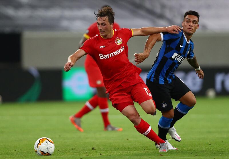 Leverkusen midflielder Julian Baumgartlinger holds off the challenge of Inter Milan's Lautaro Martinez. AFP